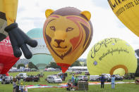 <p>Hot air Balloons are being tethered as balloonists prepare to launch at the Bristol international balloon fiesta held on August 10, 2017 in Avon, England. (Photo: Amer Ghazzal/Barcroft Images) </p>