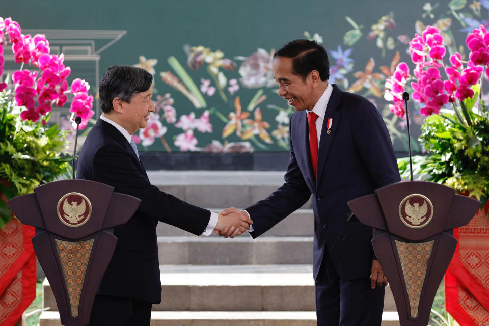Japan's Emperor Naruhito, left, shakes hands with Indonesian President Joko Widodo during a press conference following their meeting in Bogor, Indonesia, Monday, June 19, 2023. (Willy Kurniawan/Pool Photo via AP)