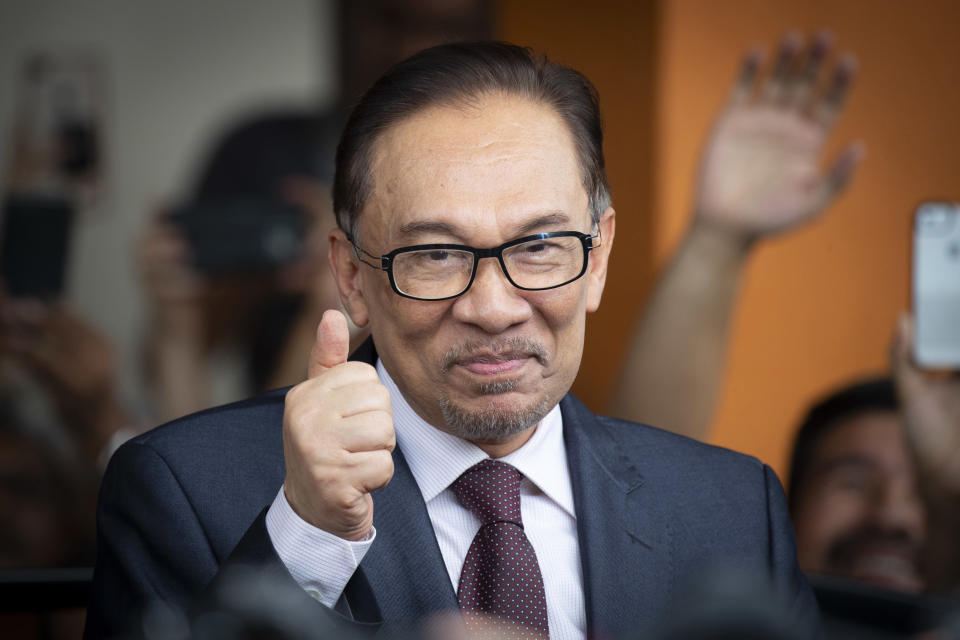 FILE - In this May 16, 2018, file photo, Anwar Ibrahim reacts to supporters as he leaves a hospital in Kuala Lumpur, Malaysia. Officials say Malaysia's prime minister-in-waiting Anwar will contest a by-election that will pave the way for his return to active politics. Lawmaker Danyal Balagopal Abdullah said Wednesday, Sept. 12, 2018, he has resigned as a member of Parliament in Port Dickson, a southern coastal town, to make way for Anwar's comeback. (AP Photo/Vincent Thian, File)