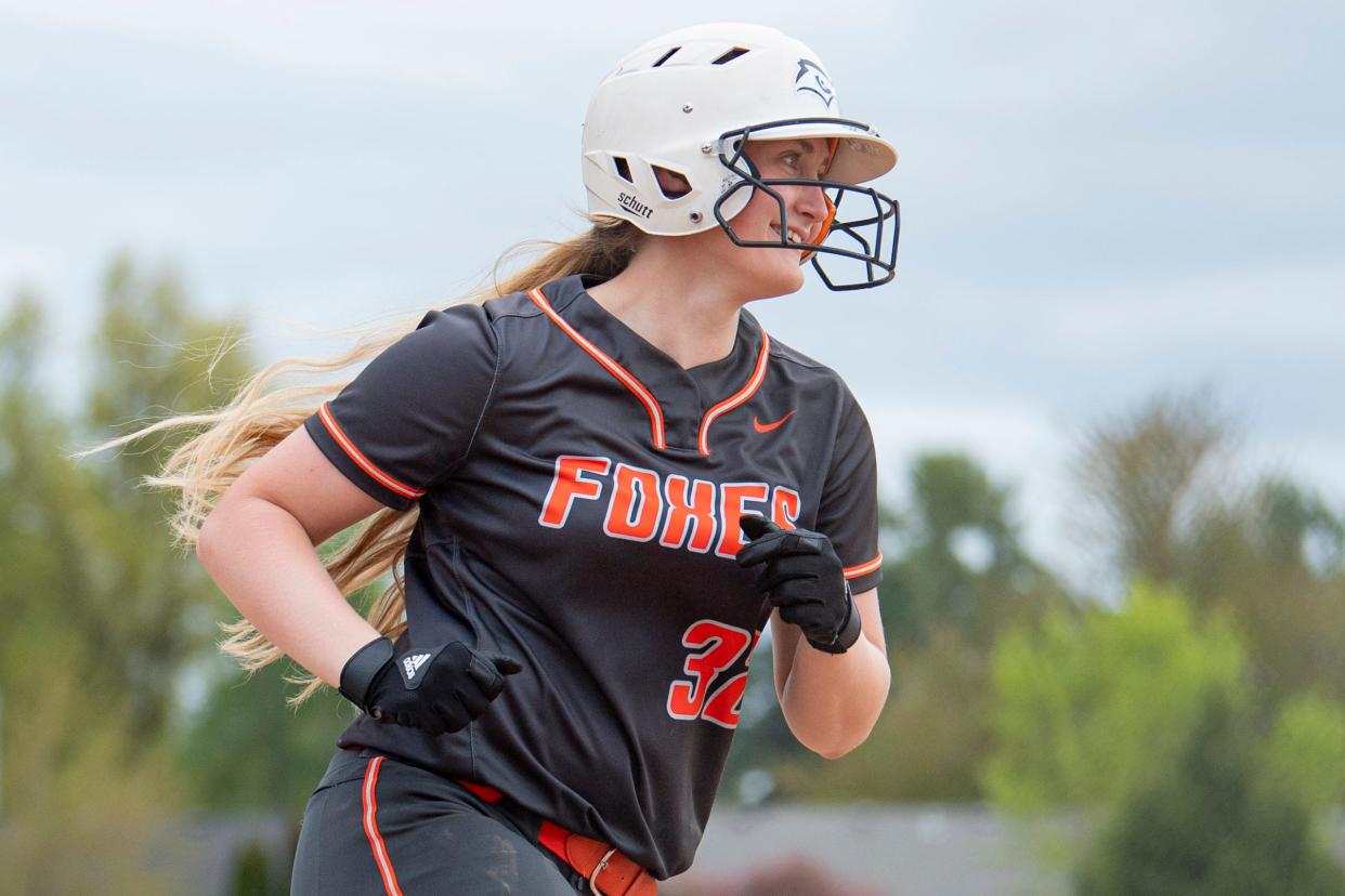 Silverton's Hannah Houts (32) smiles after scoring runs during a league matchup at Silverton High School on Wednesday, April 24, 2024, in Silverton, Ore.