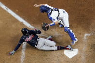 Atlanta Braves' Nick Markakis scores past Los Angeles Dodgers catcher Will Smith on a double by Cristian Pache during the fifth inning in Game 2 of a baseball National League Championship Series Tuesday, Oct. 13, 2020, in Arlington, Texas.(AP Photo/David J. Phillip)