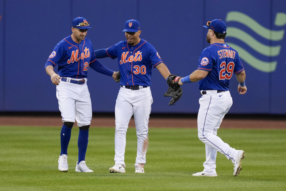 New York Mets outfielders Tim Locastro, Rafael Ortega and DJ Stewart, from left, celebrate the team's win in a baseball game against the Arizona Diamondbacks, Thursday, Sept. 14, 2023, in New York. (AP Photo/Seth Wenig)