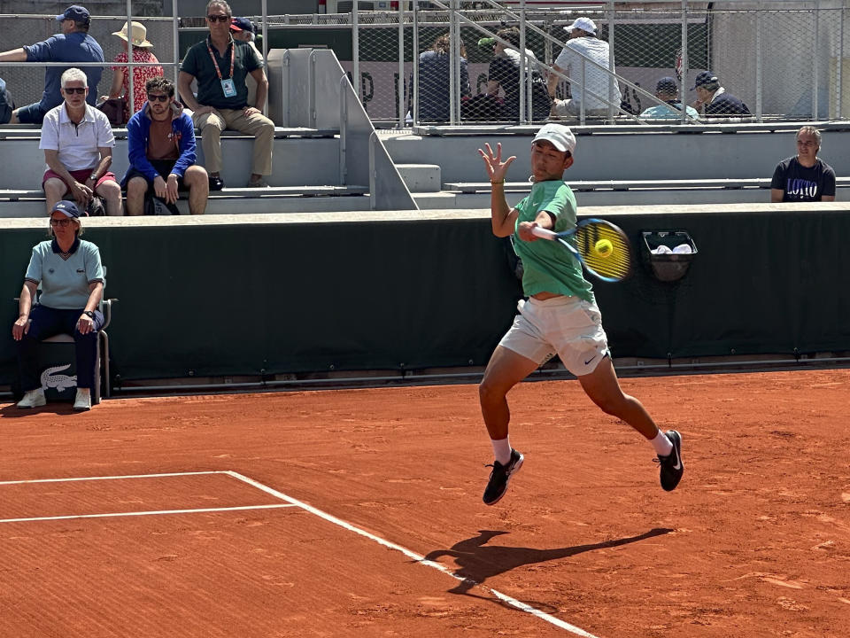 China's Shang Juncheng plays a shot against Peru's Juan Pablo Varillas during their first round match of the French Open tennis tournament at the Roland Garros stadium in Paris, Monday, May 29, 2023. (AP Photo/Howard Fendrich)