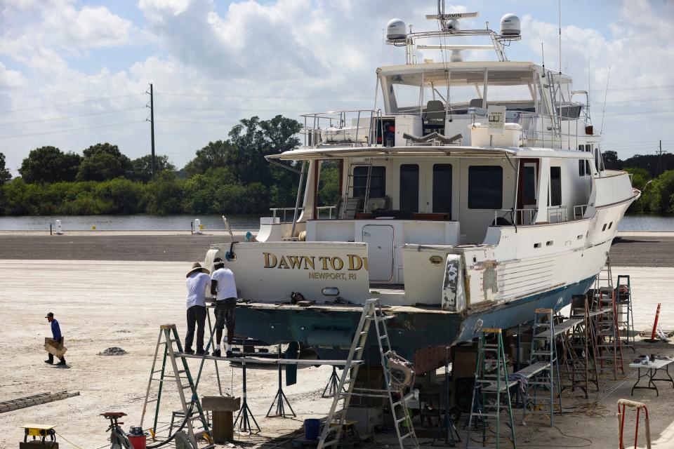 The C-44 Canal is seen in the distance as work is being done on a boat, Wednesday, Aug. 9, 2023, at Indiantown Marine Center, 21043 S.W. Citrus Blvd. The marine center is situated next to Timer Powers Park boat ramp where toxic algae was found. The state found 800 micrograms per liter of microcystis aeruginosa in the cyanobacteria, commonly called blue-green algae, according to water samples the Department of Environmental Protection took Aug. 3.