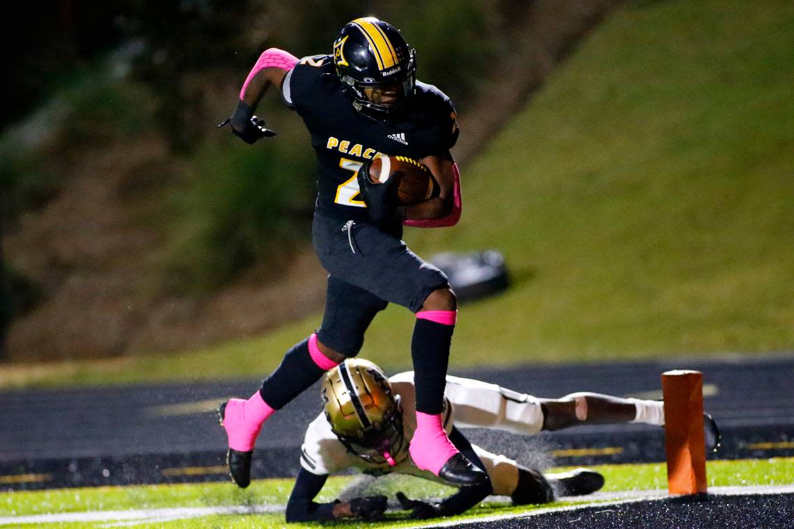 Peach County’s Christian Martin (2) eludes a would be tackle for a touchdown during the Trojans’ 35-18 win over Mary Persons Friday night.