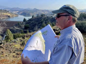 Dave Meurer, Director of Resource Environmental Solutions, shows blueprint plans for regrowing trees and vegetation on land at the Iron Gate Dam on Sunday, Sept. 17, 2023, along the Klamath River in Hornbrook, Calif. once the dam is removed and the reservoir drawn down. (AP Photo/Haven Daley)