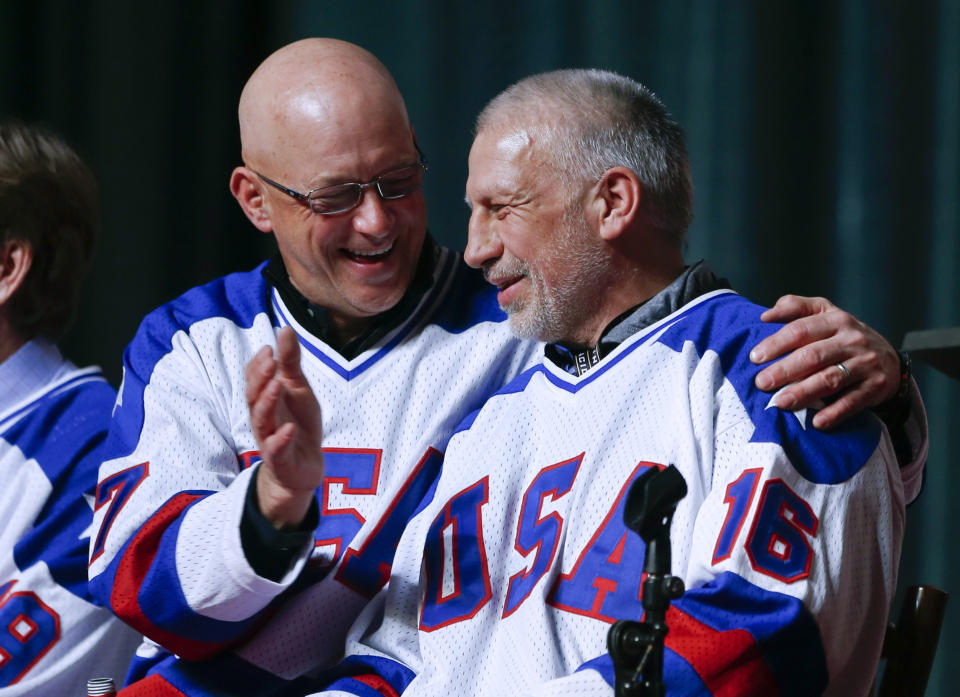 FILE - In this Feb. 21, 2015, file photo, Jack O'Callahan, left, and Mark Pavelich of the 1980 U.S. ice hockey team talk during a "Relive the Miracle" reunion at Herb Brooks Arena in Lake Placid, N.Y. Pavelich has died at a treatment center for mental illness. Officials in Anoka County, Minnesota, confirmed Friday, March 5, 2021, that Pavelich, 63, died at the Eagle's Healing Nest in Sauk Centre, Minn., Thursday morning. The cause and manner of death are still pending. (AP Photo/Mike Groll, File)