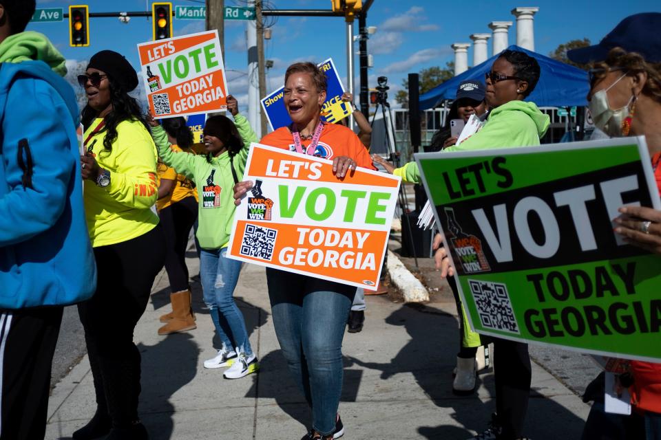 People gather during a get out the vote rally Sunday, Nov. 27, 2022, in Atlanta, during early voting for the Senate runoff election.