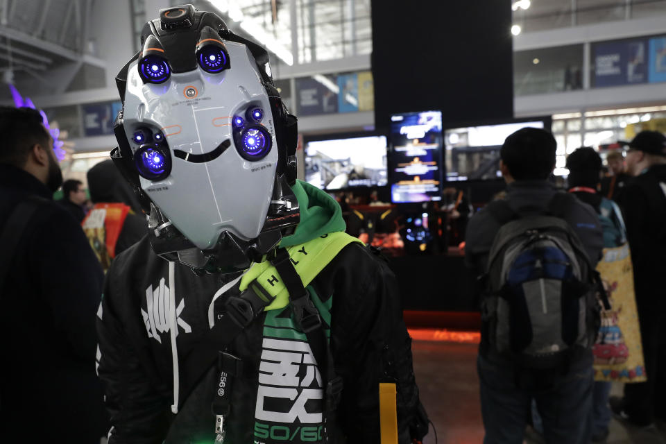 Joseph Fedo, of Scottsdale, Ariz., is dressed as "Telos," a character of his own creation, Thursday, Feb. 27, 2020, at the Pax East conference, in Boston. Thousands of gaming enthusiasts attended the Pax East conference that opened in Boston on Thursday, but a marquee industry player was missing: PlayStation-maker Sony. (AP Photo/Steven Senne)