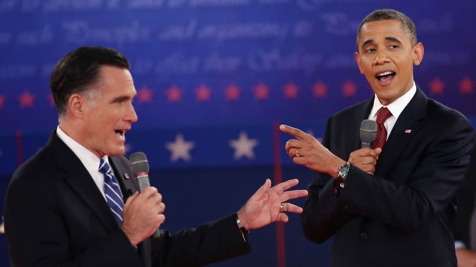 Republican presidential candidate Mitt Romney and President Barack Obama talk over each other as they answer questions during a town hall style debate at Hofstra University on October 16, 2012, in Hempstead, New York. - John Moore/Getty Images