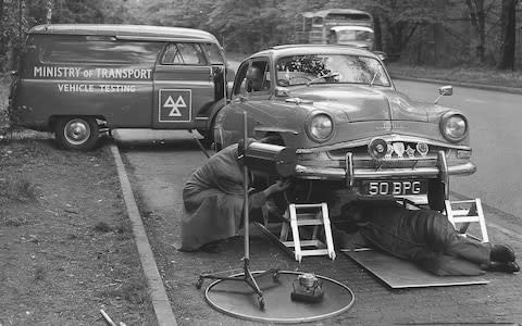 A Ministry of Transport mobile MOT testing station on the A3 at Wisley Surrey testing for lights, brakes, silencers and steering. The car being tested passed but nearly half of the 48 tested failed - Credit: PA