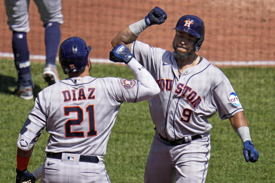 Houston Astros' Corey Julks (9) celebrates with Yainer Diaz as he returns to the dugout after hitting a solo home run off Pittsburgh Pirates starting pitcher Rich Hill during the fourth inning of a baseball game in Pittsburgh, Wednesday, April 12, 2023. (AP Photo/Gene J. Puskar)