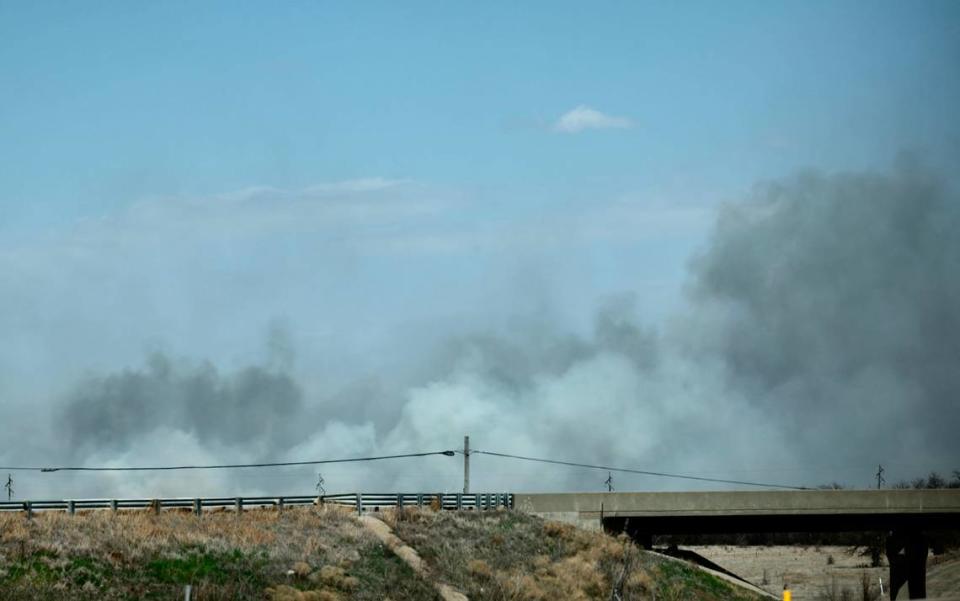 Smoke can be seen from a fire that burns west of El Dorado on Friday.
