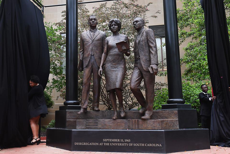 A statue unveiling Friday, April 19, 2024 honors the first three Black students to enroll in the University of South Carolina
post-reconstruction. 
Greenville native Robert G. Anderson joins Henrie Monteith Treadwell and James L. Solomon Jr., on the desegregation monument near the McKissick Museum.