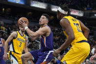 Phoenix Suns' Devin Booker goes to the basket against Indiana Pacers' Myles Turner (33) during the second half of an NBA basketball game, Friday, Jan. 14, 2022, in Indianapolis. (AP Photo/Darron Cummings)