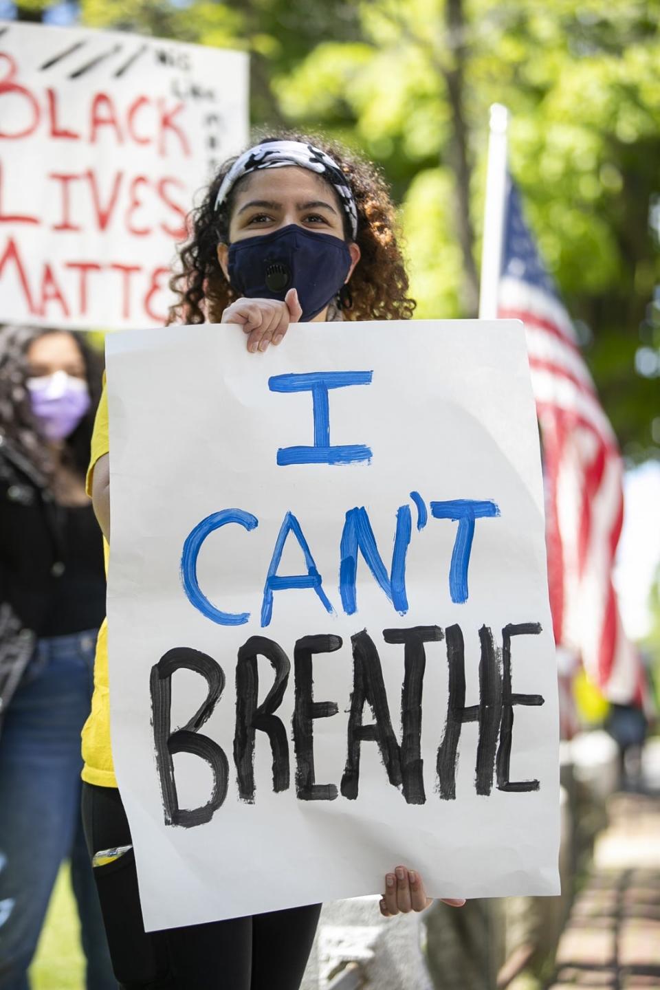 Shanzai Ikhlas, 18, of Raynham holds a sign with the words "I Can't Breathe," in Central Square in Bridgewater on Monday morning, June 1, 2020. The protest is held in response to the death of George Floyd in Minneapolis.
