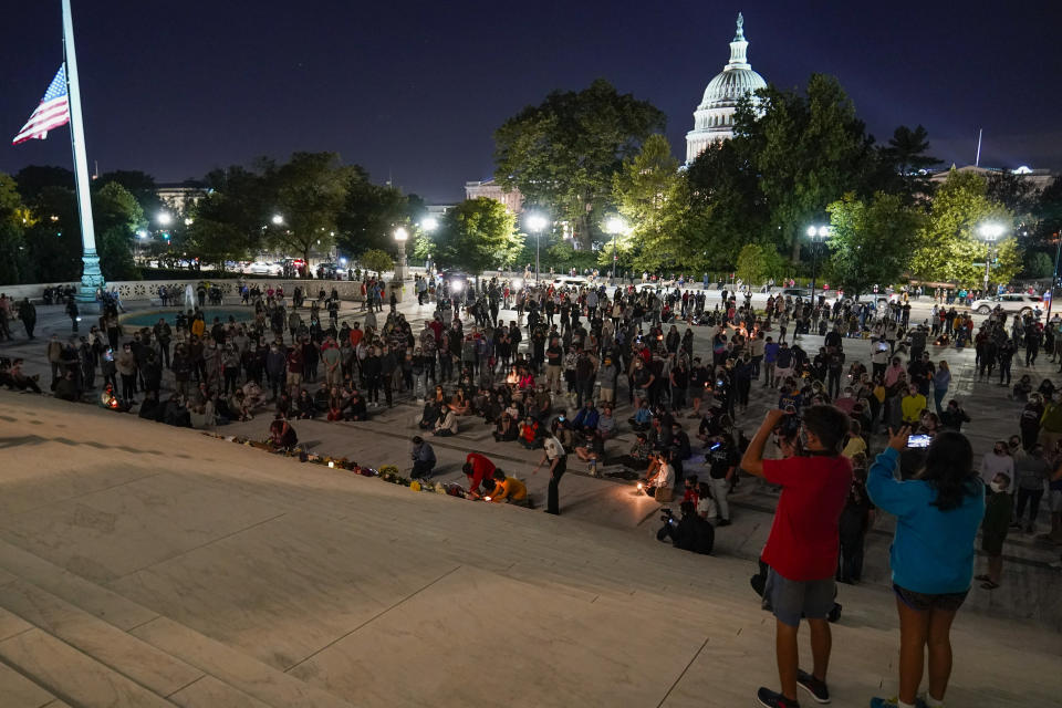 People gather at the Supreme Court Friday, Sept. 18, 2020, in Washington, after the Supreme Court announced that Supreme Court Justice Ruth Bader Ginsburg has died of metastatic pancreatic cancer at age 87. (AP Photo/Alex Brandon)