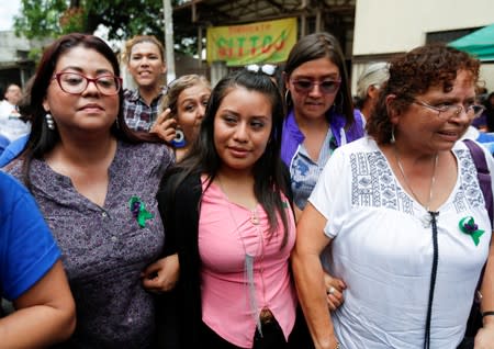 Evelyn Hernandez, who was sentenced to 30 years in prison for a suspected abortion, leaves with Salvadoran feminist and social activist Morena Herrera and attorney Angelica Rivas after being absolved at a hearing in Ciudad Delgado