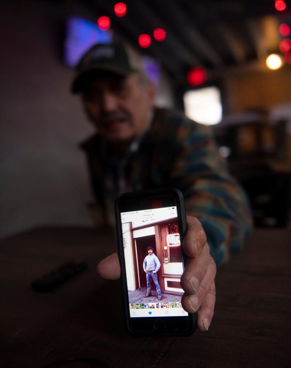 Mike Miller shows an old photo taken in front of Taco Tontos, the Kent restaurant that derived its name from his nickname.