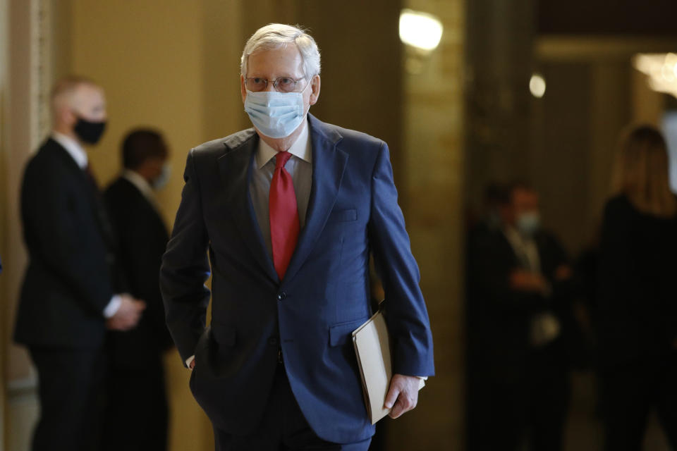 Senate Majority Leader Mitch McConnell of Ky., wears a face mask to protect against the spread of the new coronavirus as he walks to the Senate chamber after meeting with Vice President Mike Pence and Treasury Secretary Steve Mnuchin on Capitol Hill in Washington, Tuesday, May 19, 2020. (AP Photo/Patrick Semansky)