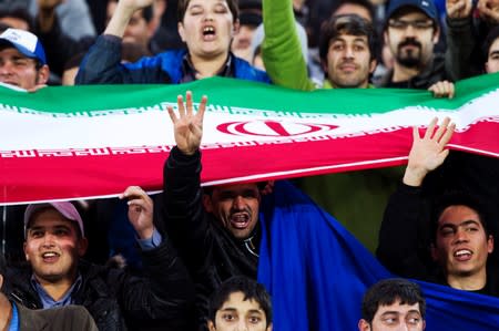 FILE PHOTO: Fans of Esteghlal cheer during their AFC Champions League soccer match playoff against Al Ittifaq, in Tehran