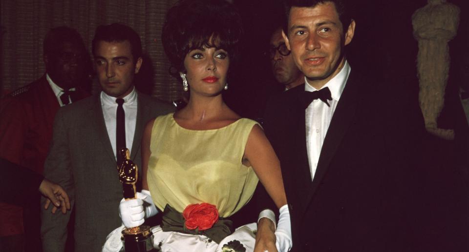 Elizabeth Taylor wears Christian Dior Oscar dress to 33rd annual Academy Awards in 1961 with fourth husband Eddie Fisher. (Getty Images)