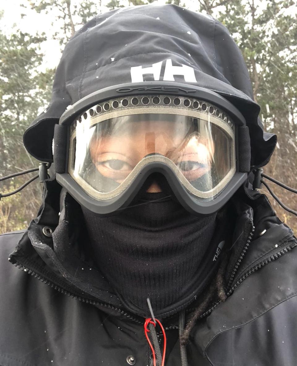 Woman with ski goggles, face mask, and jacket in Japan.