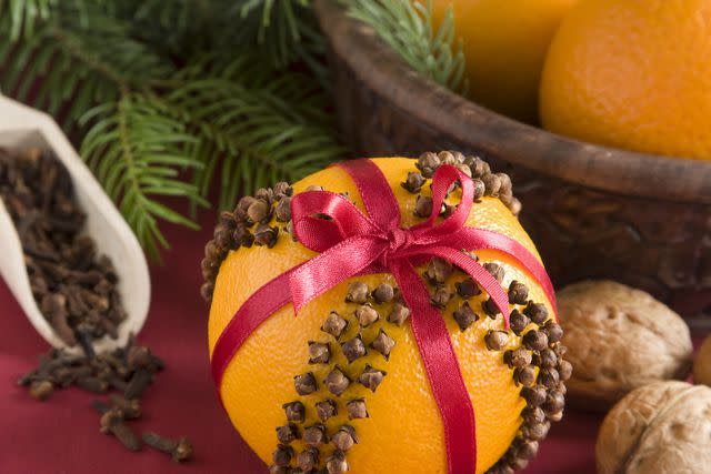 karma_pema / Getty Images Orange pomander pall with cloves