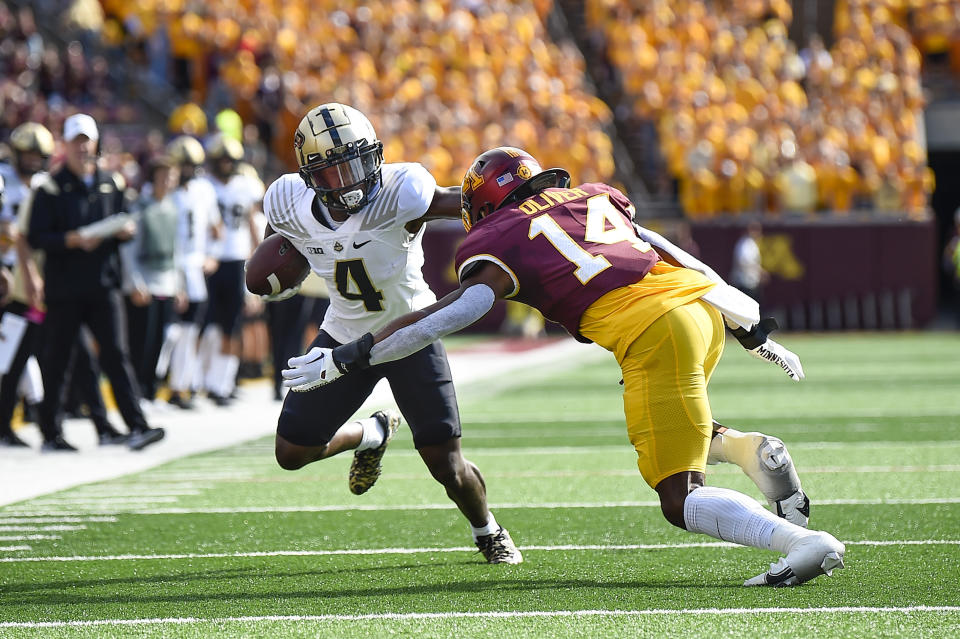 Purdue wide receiver Deion Burks (4) stiff arms Minnesota linebacker Braelen Oliver during the first half an NCAA college football game on Saturday, Oct. 1, 2022, in Minneapolis. Purdue won 20-10. (AP Photo/Craig Lassig)