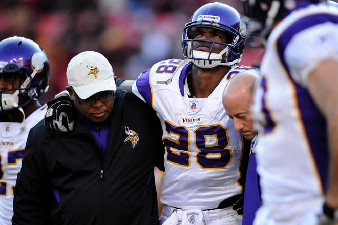 LANDOVER, MD - DECEMBER 24: Running back Adrian Peterson #28 of the Minnesota Vikings is helped off the field after being injured in the third quarter against the Washington Redskins at FedEx Field on December 24, 2011 in Landover, Maryland. (Photo by Patrick Smith/Getty Images)