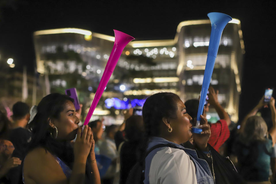 Supporters of Salvador President Nayib Bukele, who is seeking re-election, celebrate results of a general election at the Gerardo Barrios square in downtown San Salvador, El Salvador, Sunday, Feb. 4, 2024. (AP Photo/Salvador Melendez)