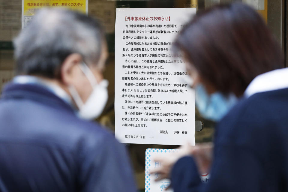 This Feb. 17, 2020, photo shows a notice at Makita General Hospital in Tokyo announcing it will suspend outpatient medical treatment after a doctor and nurse working at the hospital were confirmed as infected with new coronavirus. Hospitals in Japan are increasingly turning away sick people in ambulances as the country braces for a surge in coronavirus infections. The Japanese Association for Acute Medicine and the Japanese Society for Emergency Medicine say emergency medicine has already collapsed with many hospitals refusing to treat people including those suffering strokes, heart attacks and external injuries. (Takuya Inaba/Kyodo News via AP)