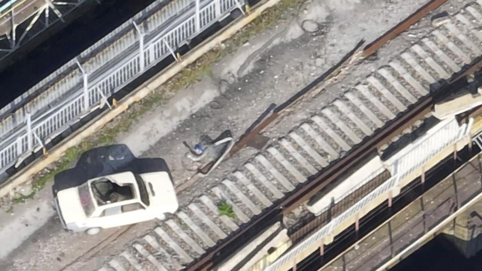 This photo taken from drone footage, provided by the Ukrainian military and dated May 28, 2023, shows a car on the Kakhovka Dam that appears to be laden with explosives. The dam collapsed June 6, while it was under Russian control. (Ukrainian military via AP)