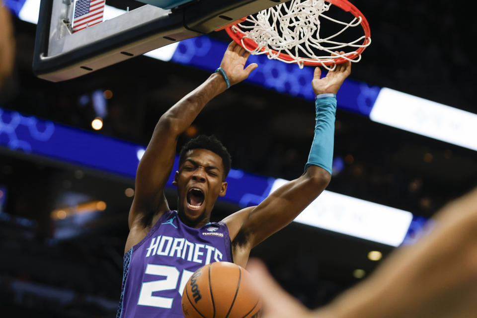 Charlotte Hornets forward Brandon Miller yells as he dunks against the Denver Nuggets during the first half of an NBA basketball game in Charlotte, N.C., Saturday, Dec. 23, 2023. (AP Photo/Nell Redmond)