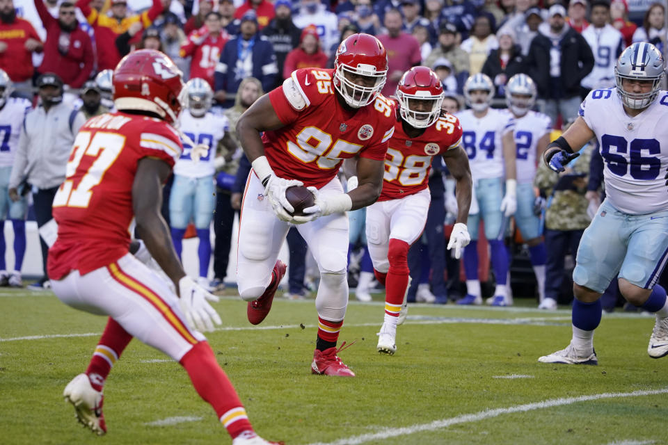 Kansas City Chiefs defensive tackle Chris Jones runs with the ball after recovering a fumble during the first half of an NFL football game against the Dallas Cowboys Sunday, Nov. 21, 2021, in Kansas City, Mo. (AP Photo/Ed Zurga)