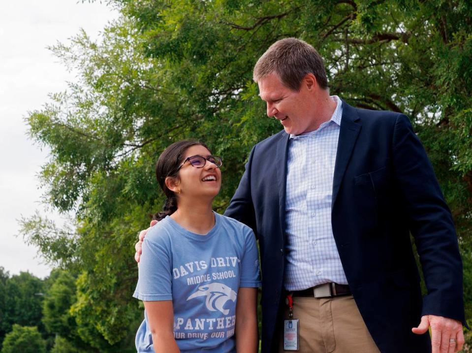 Davis Drive Middle School seventh-grader Ananya Rao Prassanna smiles as she is greeted by Principal Michael Hokenberg during a celebration on Monday, June 3, 2024, in Cary, N.C. honoring Prassanna’s third-place finish in the Scripps National Spelling Bee. 