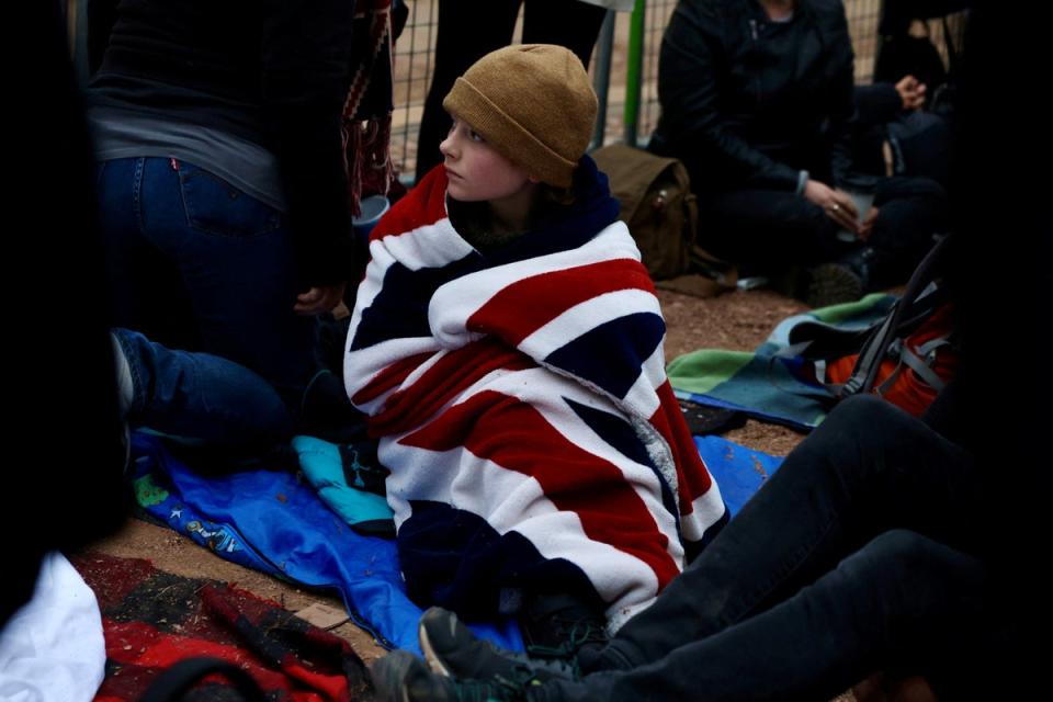 A person sits on The Mall on the day of the state funeral and burial of Britain’s Queen Elizabeth (REUTERS)