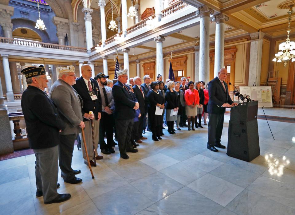 Retired Brigadier General Jim Bauerle is surrounded by people from military/veterans groups, faith leaders, community groups, and service organizations, as he speaks in opposition of Senate Bill 613, at the Indiana Statehouse, Monday, March 11, 2019.  They are in opposition of the massive expansion of payday and subprime lending rights, seen in SB 613.
