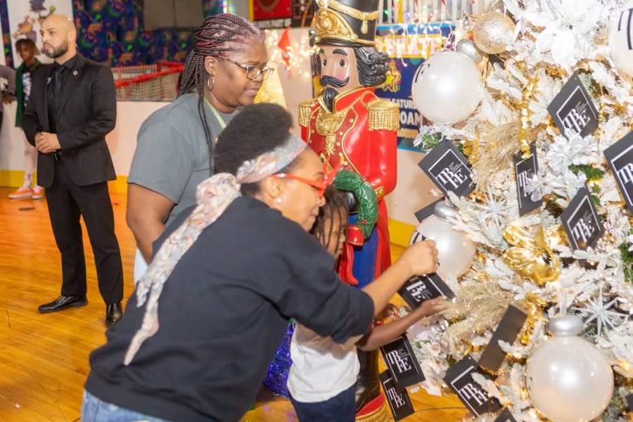 <em>Families pick from the TBFF giving tree. Courtesy: Holly K Photography</em>