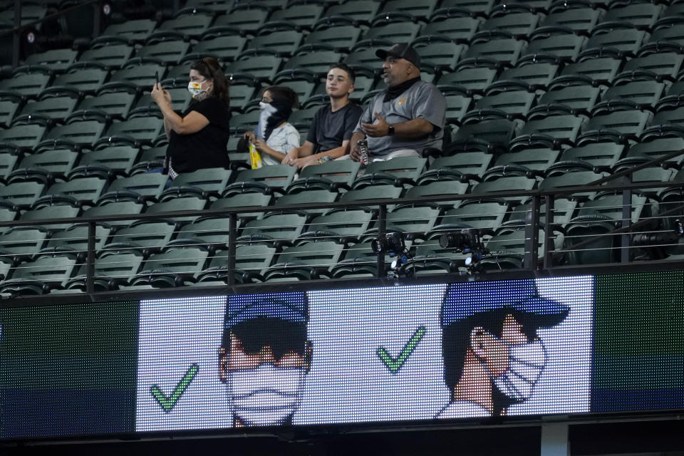 Fans watch during batting practice before Game 1 of a baseball National League Championship Series between the Los Angeles Dodgers and the Atlanta Braves Monday, Oct. 12, 2020, in Arlington, Texas. (AP Photo/Tony Gutierrez)