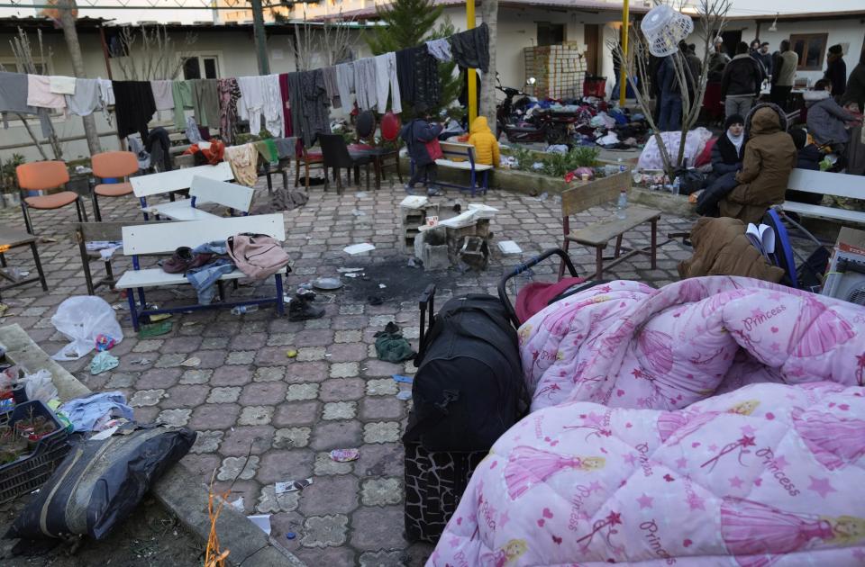 FILE - Syrians gather at a shelter in Antakya, southeastern Turkey, Friday, Feb. 10, 2023. The shelter, operated by Molham, a team of Syrian volunteers, was set up soon after the earthquake struck, offering temporary shelter, hot meals, and transportation out of the devastated city to hundreds of the thousands of Syrian refugees who fled years ago after war broke out in their hometown and now find themselves once again displaced and homeless. For Syrians and Ukrainians fleeing the violence back home, the earthquake that struck in Turkey and Syria is but the latest tragedy. (AP Photo/Hussein Malla, File)