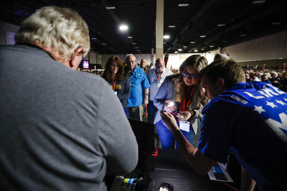 Delegates stand in line at the help desk to get their voting machines programmed so they can vote at the GOP Convention at the Mountain America Convention Center in Sandy, Utah, Saturday, April 23, 2022. (Adam Fondren/The Deseret News via AP)