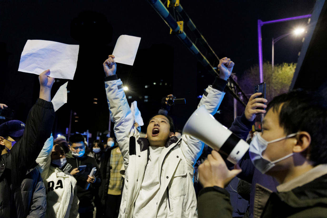 FTSE 100 People hold white sheets of paper in protest over coronavirus disease (COVID-19) restrictions after a vigil for the victims of a fire in Urumqi, as outbreaks of COVID-19 continue, in Beijing, China, November 28, 2022. REUTERS/Thomas Peter