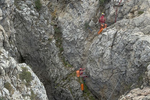 <p>Huseyin Yildiz/IHA via AP</p> European Cave Rescue Association (ECRA) members work next to the entrance of Morca cave near Anamur, southern Turkey, Thursday, Sept. 7, 2023.