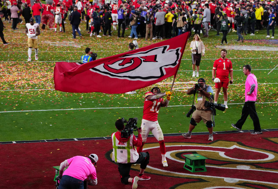 Chiefs running back Isiah Pacheco waves a flag after defeating the San Francisco 49ers