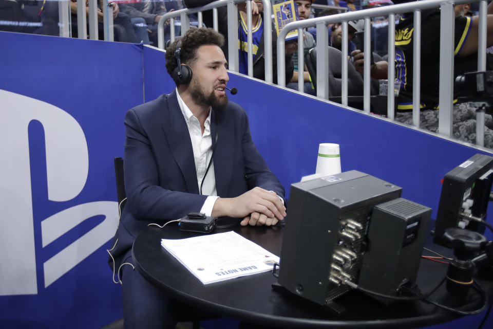 Injured Golden State Warriors guard Klay Thompson gives television analysis during the first half of an NBA basketball game between the Warriors and the Chicago Bulls in San Francisco, Wednesday, Nov. 27, 2019. (AP Photo/Jeff Chiu)