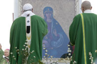 Pope Francis, left with back to camera, blesses an image of the Virgin Mary during a Mass at Santakos Park, in Kaunas, Lithuania, Sunday, Sept. 23, 2018. Francis is paying tribute to Lithuanians who suffered and died during Soviet and Nazi occupations on the day the country remembers the near-extermination of its centuries-old Jewish community during the Holocaust. (AP Photo/Andrew Medichini)