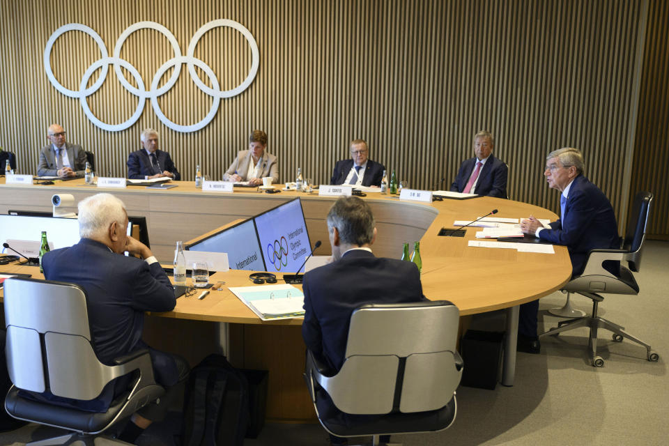 International Olympic Committee (IOC) President Thomas Bach, right, speaks at the opening of the executive board meeting of the International Olympic Committee (IOC) in Lausanne, Switzerland, Tuesday, March 28, 2023. The IOC Executive Board is set to discuss the results of consultations regarding the status of athletes from Russia and Belarus in its meeting set to run until March 30. (Laurent Gillieron/Keystone via AP)