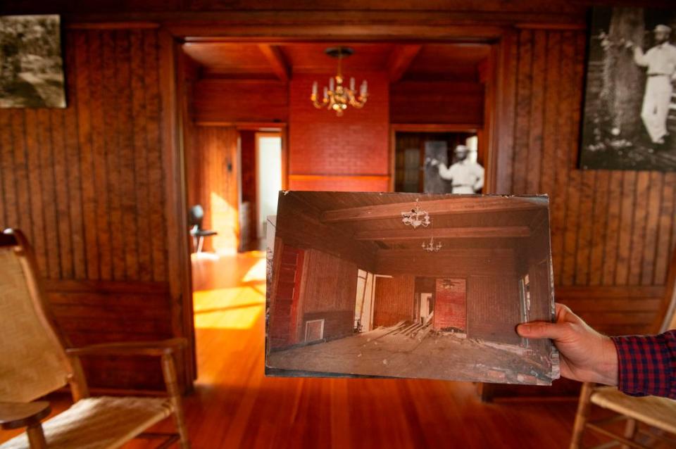 Historic Preservation Coordinator for the Mississippi Gulf Coast National Heritage Area, Jeff Rosenberg, holds up a photo of the main room at Bon Silene after Hurricane Katrina while giving a tour of the room in Ocean Springs on Wednesday, Oct. 4, 2023.
