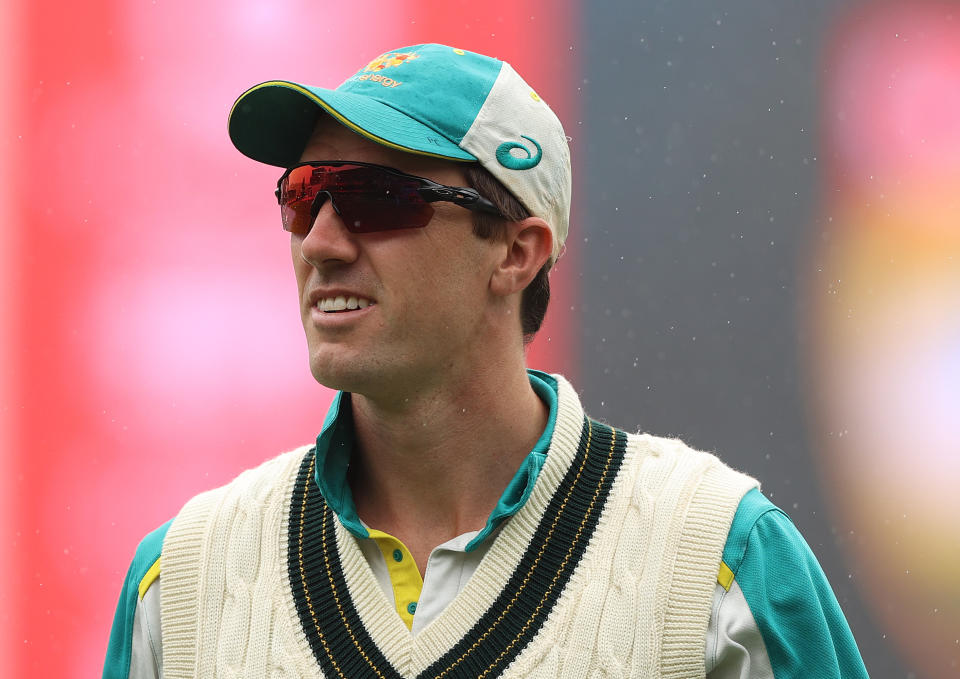 Pat Cummins walks off the ground as rain falls prior to day one of the Fifth Test in the Ashes series.